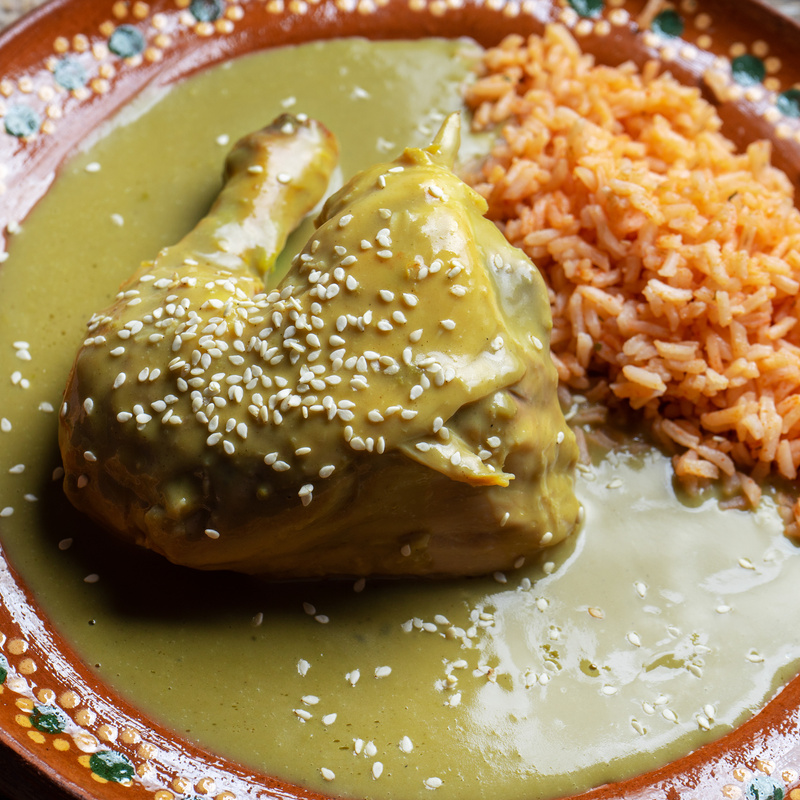Mexican chicken with green mole sauce and red rice