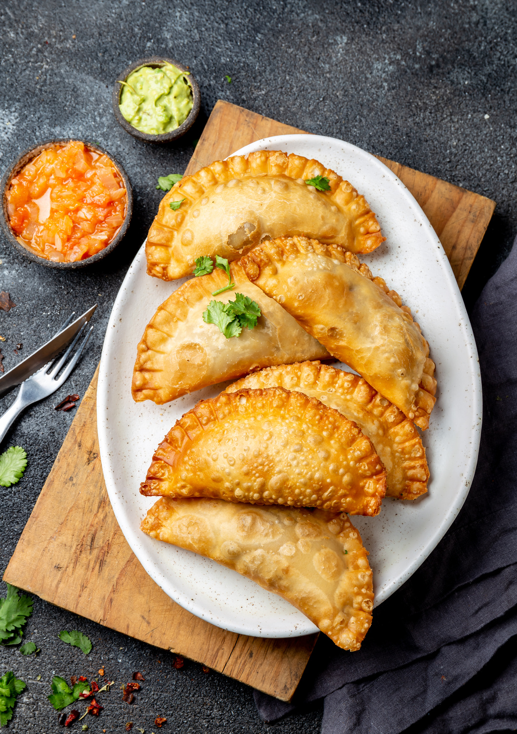 Latin American Fried Empanadas with Tomato and Avocado Sauces. Top View