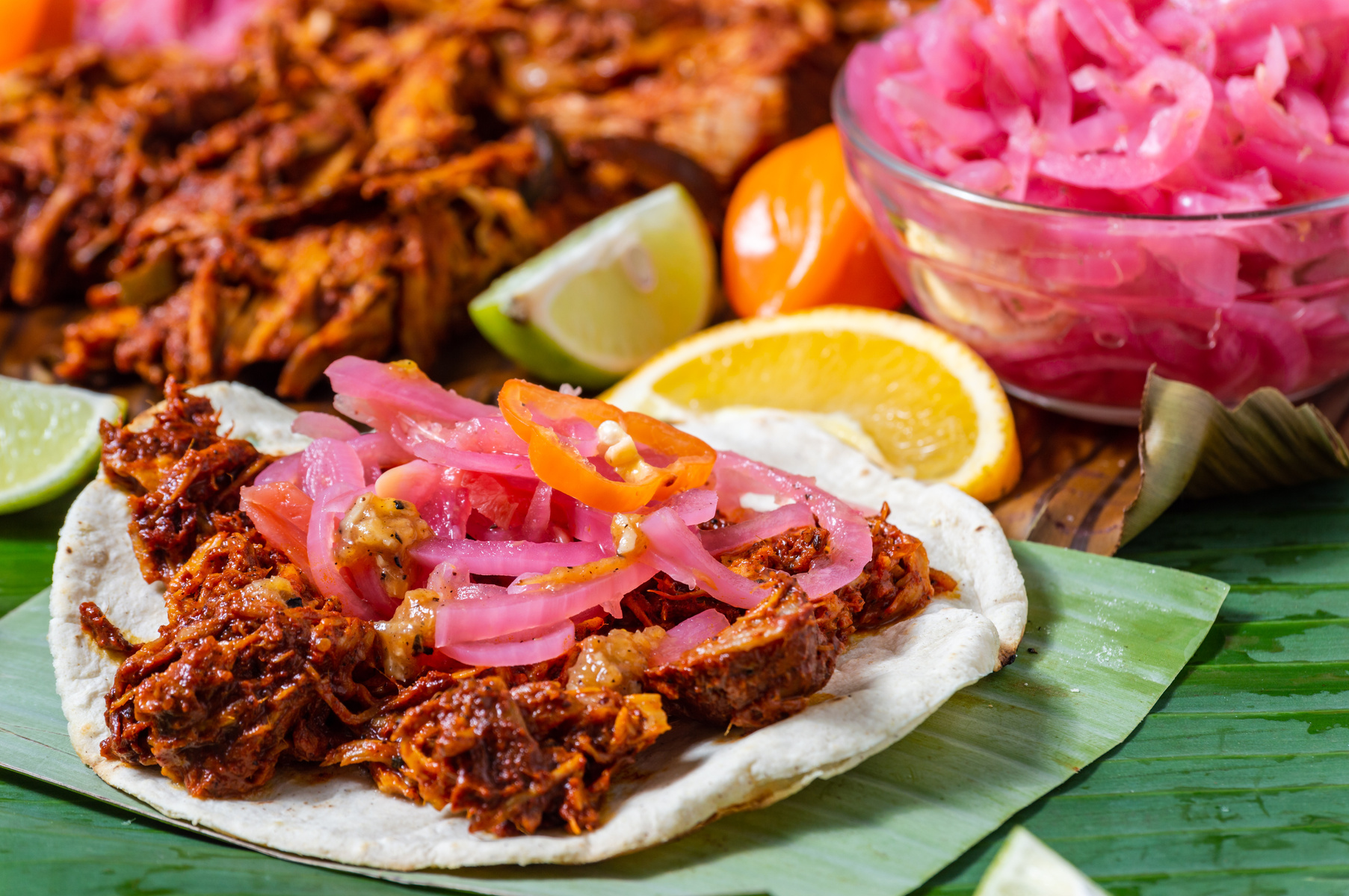 Tostadas of cochinita pibil, served with traditional condiments
